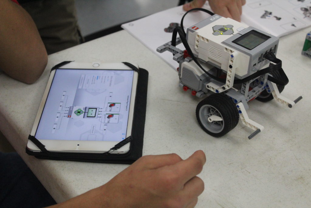 student programming a Lego Roboti