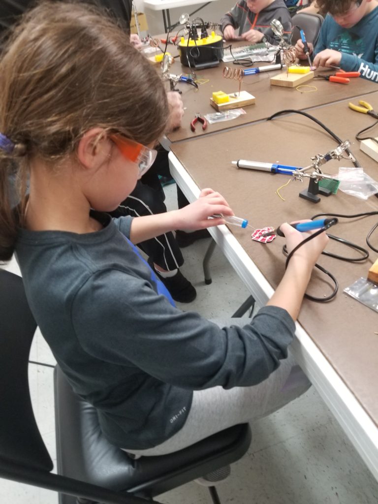 student soldering in STEM Fun class