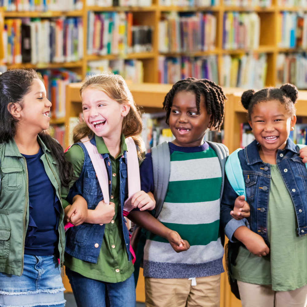 Kids laughing together in a library