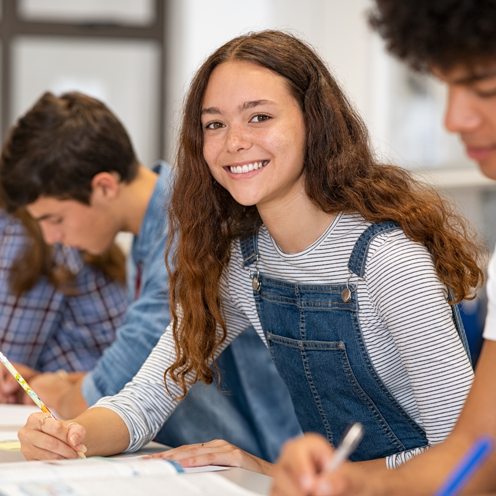 A girl in cute overalls taking an exam