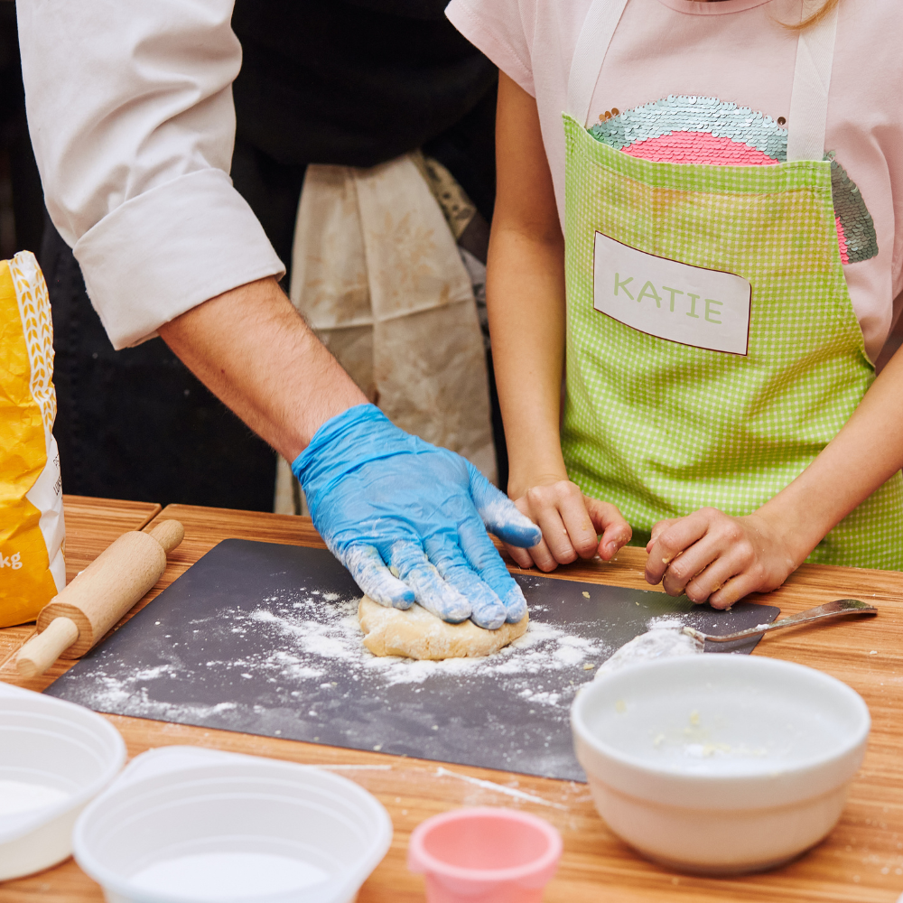 Child learning how to knead dough