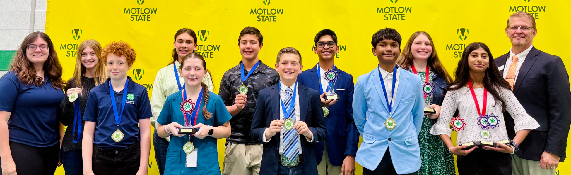 group of students stand with their awards from project achievement day