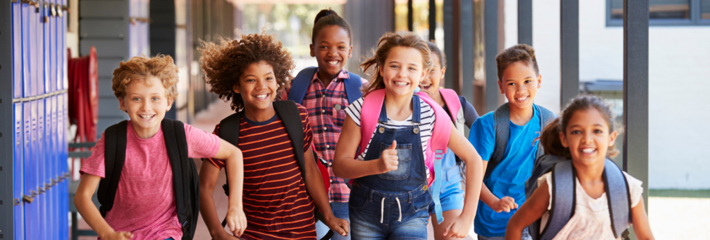 Kids running down school hallway